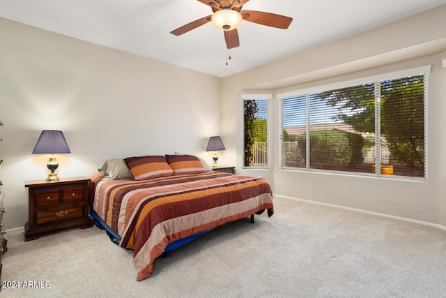 bedroom with ceiling fan and light colored carpet