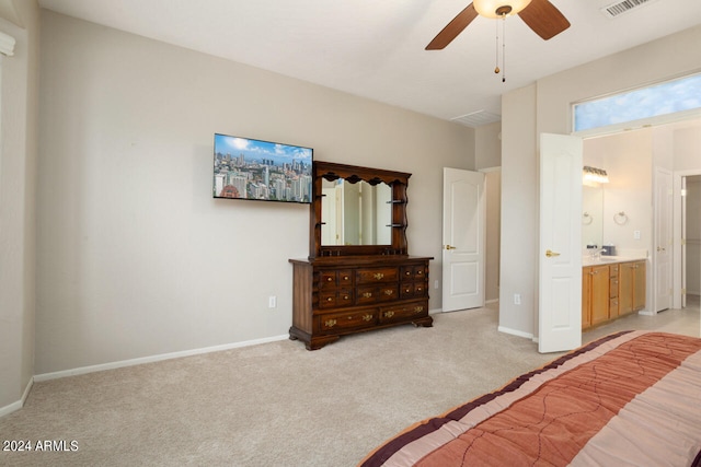 unfurnished bedroom featuring ceiling fan, light colored carpet, and ensuite bathroom