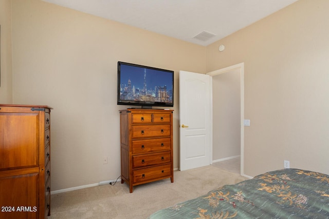 bedroom featuring light carpet