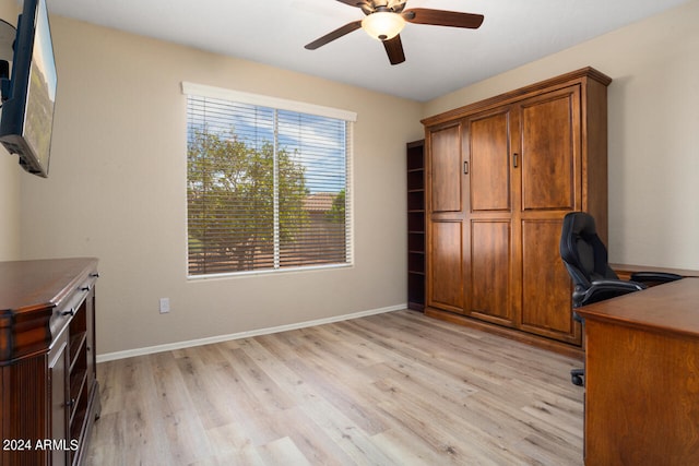 unfurnished office featuring ceiling fan and light wood-type flooring