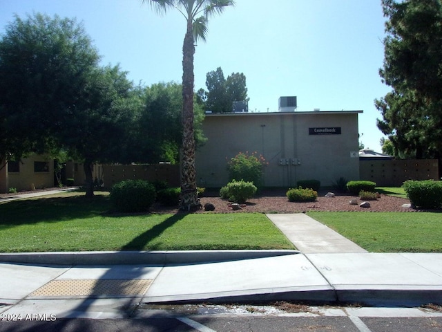 view of front facade featuring fence and a front lawn