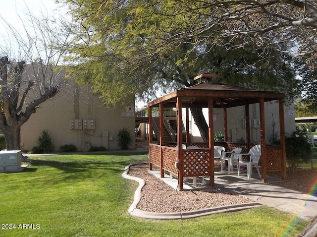 view of yard featuring a gazebo, a patio area, and stairs