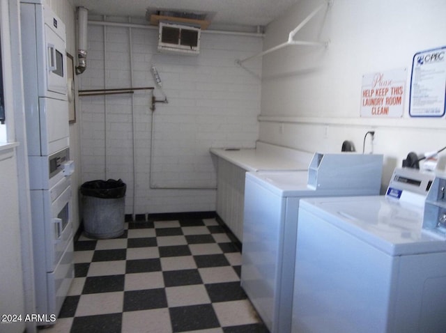 community laundry room with separate washer and dryer, stacked washer / drying machine, visible vents, and dark floors