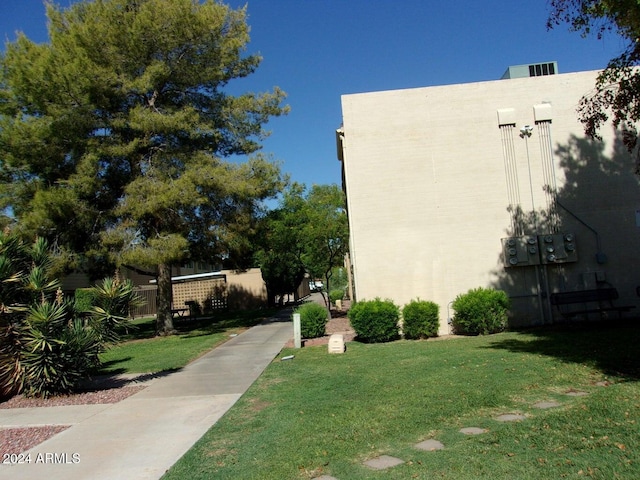 view of property exterior with a lawn