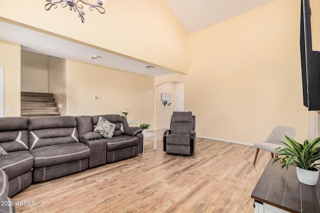 living room with high vaulted ceiling and wood-type flooring