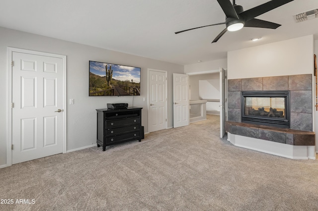 5917 N 133rd Ave, Litchfield Park, AZ 85340 - carpeted living room featuring visible vents, baseboards, a fireplace, and a ceiling fan