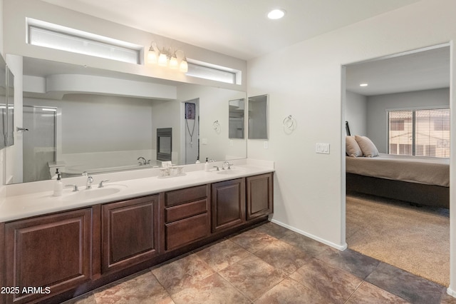 5917 N 133rd Ave, Litchfield Park, AZ 85340 - ensuite bathroom featuring baseboards, double vanity, a sink, ensuite bathroom, and a bath