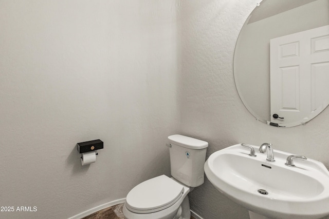 5917 N 133rd Ave, Litchfield Park, AZ 85340 - bathroom with toilet, baseboards, and a sink
