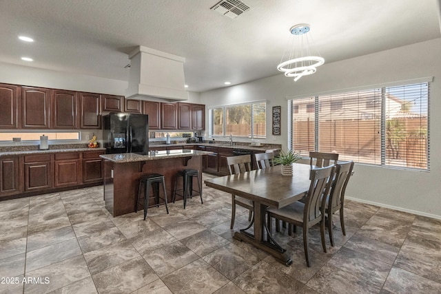 dining room featuring baseboards, visible vents, recessed lighting, a textured ceiling, and a chandelier