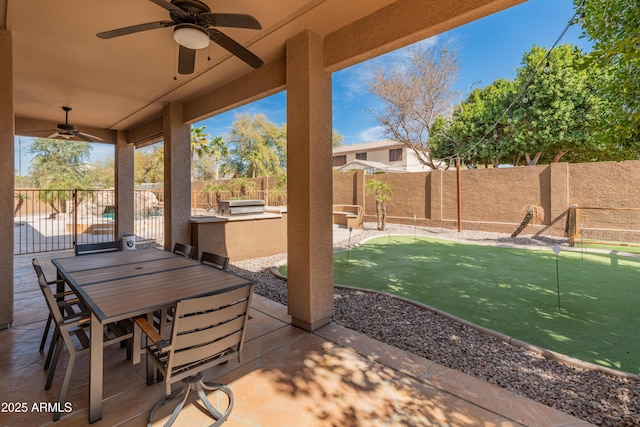 5917 N 133rd Ave, Litchfield Park, AZ 85340 - view of patio / terrace with an outdoor kitchen, outdoor dining space, a fenced backyard, and ceiling fan
