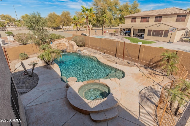 5917 N 133rd Ave, Litchfield Park, AZ 85340 - view of pool with a patio area, a fenced in pool, an in ground hot tub, and a fenced backyard