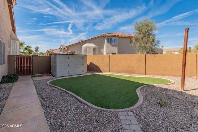 5917 N 133rd Ave, Litchfield Park, AZ 85340 - view of yard with an outdoor structure, a fenced backyard, and a gate