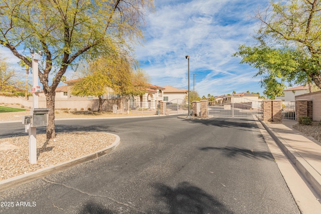 5917 N 133rd Ave, Litchfield Park, AZ 85340 - view of street with sidewalks, curbs, a gated entry, and a gate