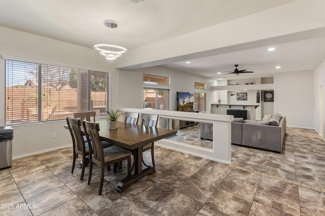 5917 N 133rd Ave, Litchfield Park, AZ 85340 - dining area with recessed lighting, baseboards, a fireplace, and ceiling fan with notable chandelier