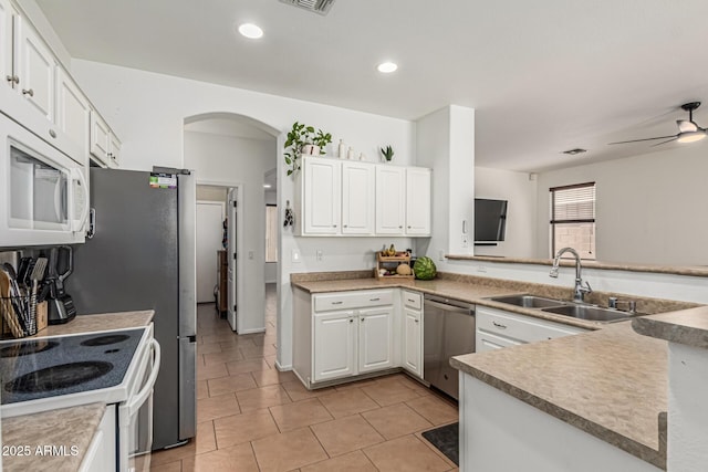609 S 122nd Dr, Avondale, AZ 85323 - kitchen featuring white appliances, arched walkways, white cabinets, a ceiling fan, and light tile patterned flooring