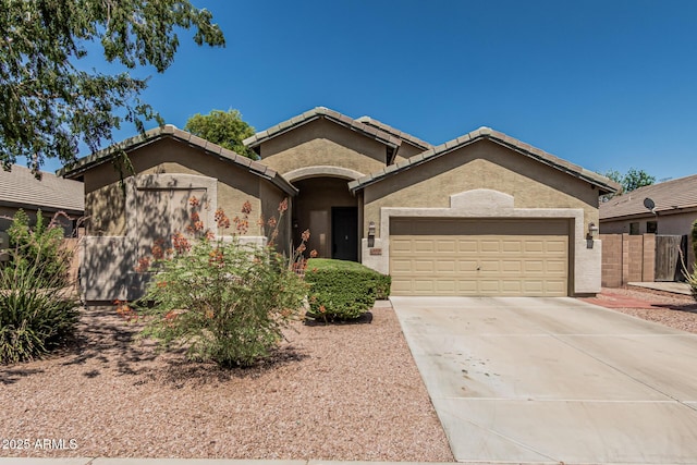 609 S 122nd Dr, Avondale, AZ 85323 - ranch-style house featuring an attached garage, concrete driveway, a tile roof, and stucco siding