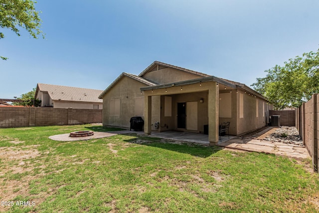 609 S 122nd Dr, Avondale, AZ 85323 - rear view of house with a fire pit, a patio area, a fenced backyard, and stucco siding