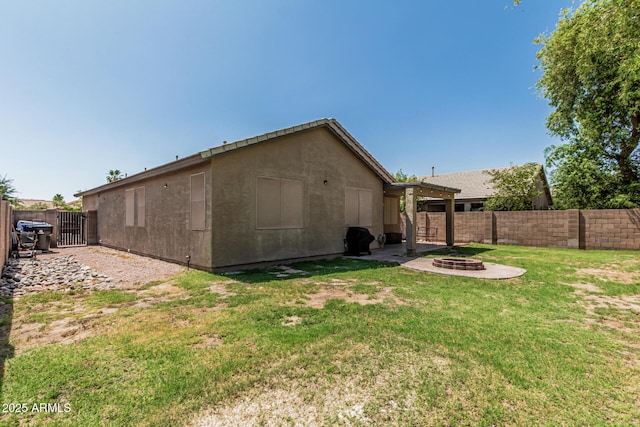 609 S 122nd Dr, Avondale, AZ 85323 - rear view of house featuring an outdoor fire pit, a fenced backyard, and a patio