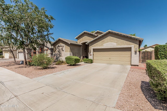 609 S 122nd Dr, Avondale, AZ 85323 - ranch-style house with driveway, an attached garage, stucco siding, and a tile roof