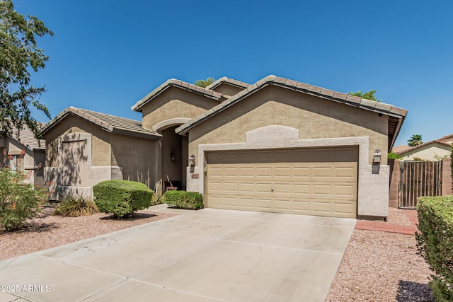 609 S 122nd Dr, Avondale, AZ 85323 - view of front of house with concrete driveway, an attached garage, stucco siding, and a tile roof