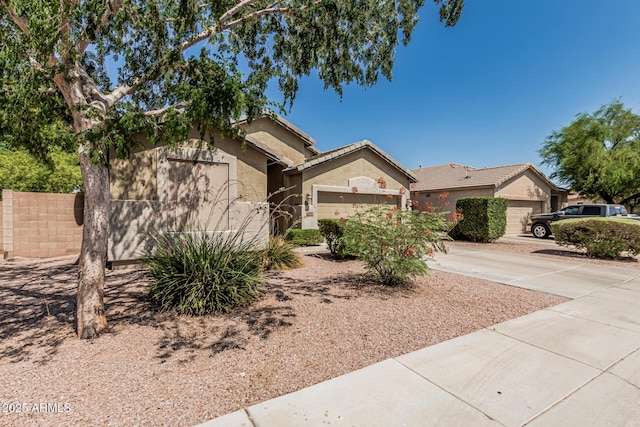 609 S 122nd Dr, Avondale, AZ 85323 - ranch-style home featuring a garage, concrete driveway, and stucco siding