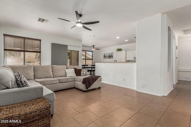 609 S 122nd Dr, Avondale, AZ 85323 - living room with a ceiling fan, light tile patterned flooring, recessed lighting, and arched walkways