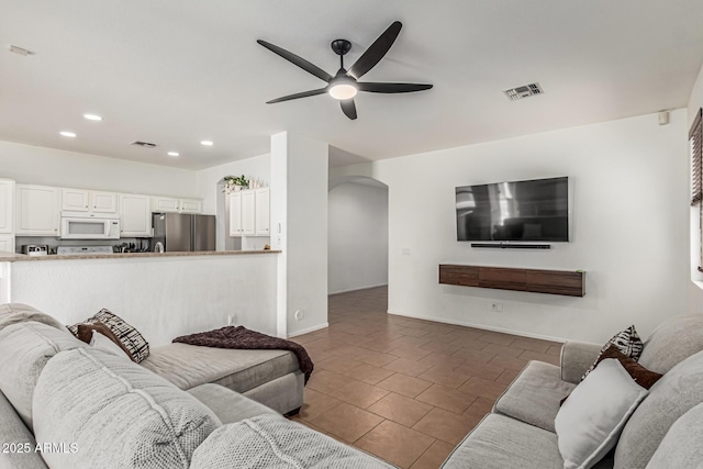 609 S 122nd Dr, Avondale, AZ 85323 - living area featuring arched walkways, a ceiling fan, recessed lighting, and tile patterned floors