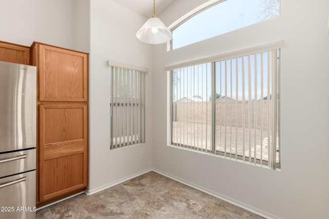 14936 W Maui Ln, Surprise, AZ 85379 - unfurnished dining area featuring a towering ceiling and baseboards