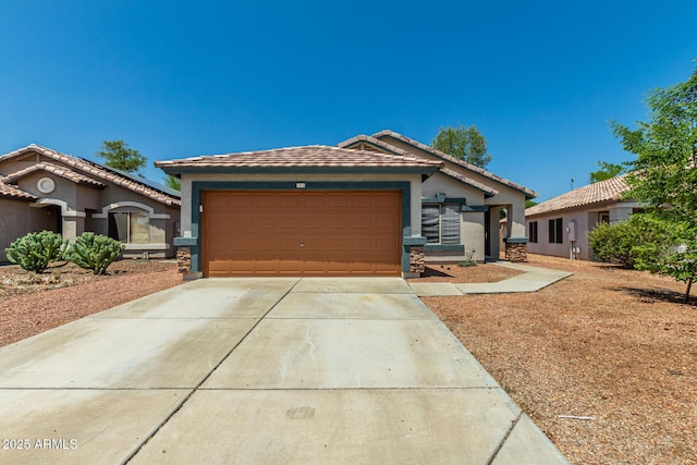14936 W Maui Ln, Surprise, AZ 85379 - ranch-style house featuring an attached garage, stucco siding, concrete driveway, and stone siding