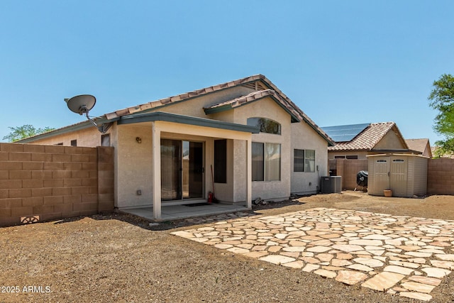 14936 W Maui Ln, Surprise, AZ 85379 - back of property with a storage unit, a fenced backyard, a patio area, stucco siding, and a tile roof