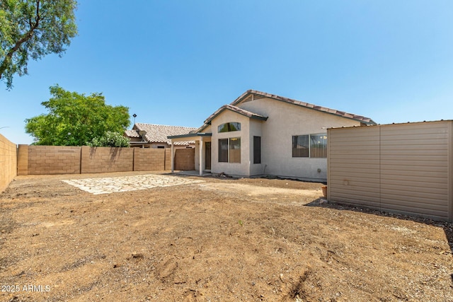 14936 W Maui Ln, Surprise, AZ 85379 - back of property with a fenced backyard, a patio, an attached garage, and stucco siding