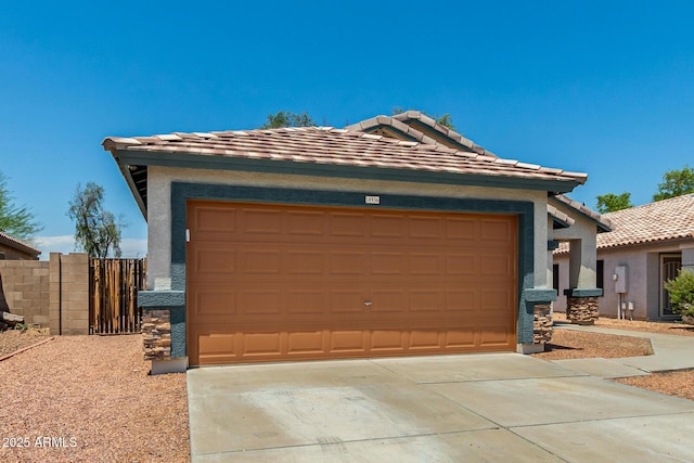 14936 W Maui Ln, Surprise, AZ 85379 - view of front of property featuring a garage, concrete driveway, stucco siding, and a tile roof