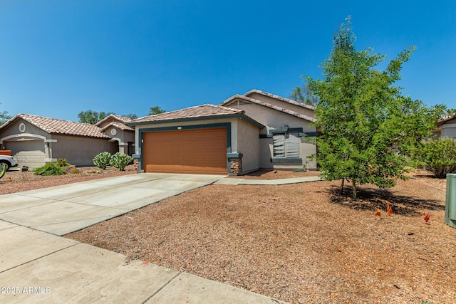 14936 W Maui Ln, Surprise, AZ 85379 - view of front of house featuring stucco siding, a garage, concrete driveway, and a tile roof