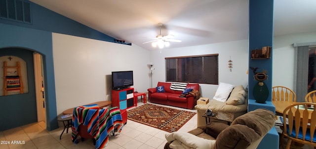 living room with ceiling fan, light tile patterned floors, and lofted ceiling