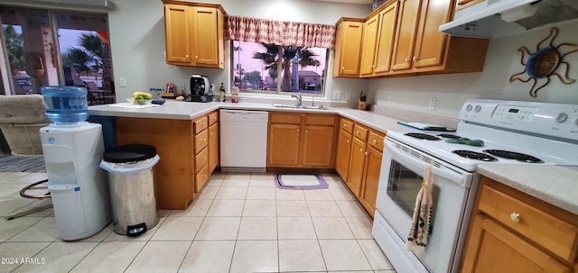 kitchen featuring kitchen peninsula, sink, light tile patterned floors, and white appliances