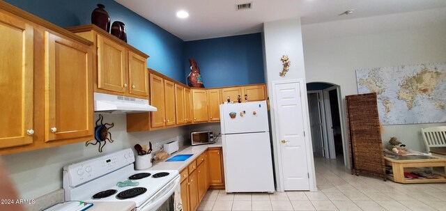 kitchen with white appliances and light tile patterned flooring