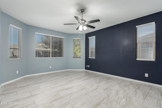 unfurnished room with ceiling fan