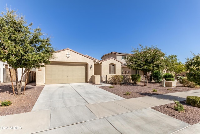 19034 W Yucatan Dr, Surprise, AZ 85388 - mediterranean / spanish-style home with driveway, an attached garage, fence, and stucco siding