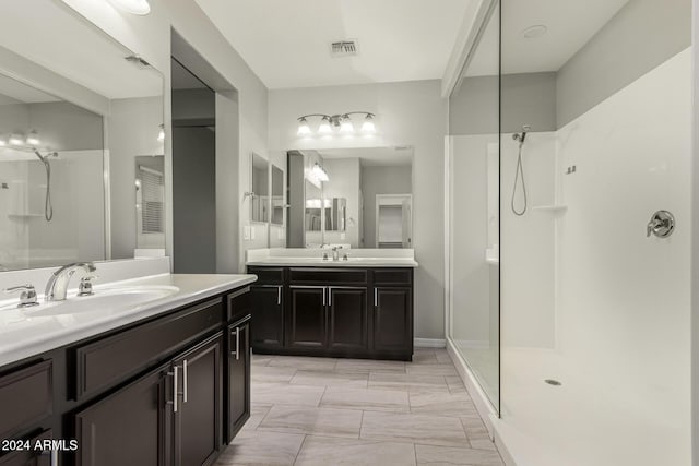 19034 W Yucatan Dr, Surprise, AZ 85388 - bathroom with a walk in shower, two vanities, and marble finish flooring