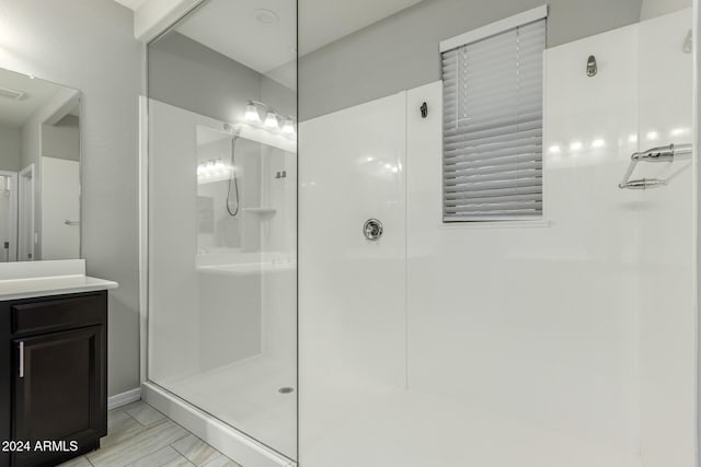 bathroom with vanity and a shower with shower door