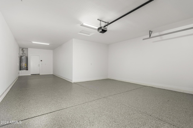 19034 W Yucatan Dr, Surprise, AZ 85388 - garage with water heater, a garage door opener, and baseboards