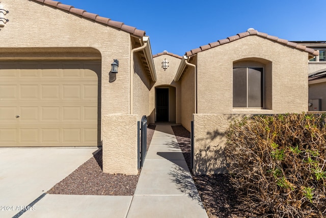 view of exterior entry featuring a garage