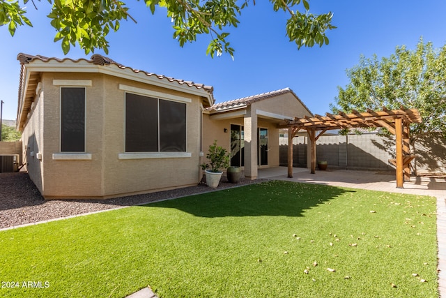 back of property with a yard, a patio, central AC unit, and a pergola