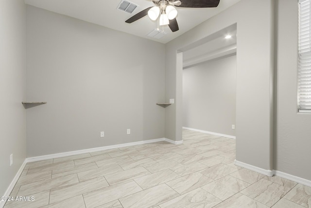 19034 W Yucatan Dr, Surprise, AZ 85388 - unfurnished bedroom featuring ceiling fan, baseboards, and light marble finish flooring
