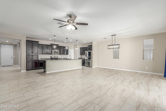 19034 W Yucatan Dr, Surprise, AZ 85388 - kitchen with appliances with stainless steel finishes, open floor plan, a ceiling fan, recessed lighting, and pendant lighting