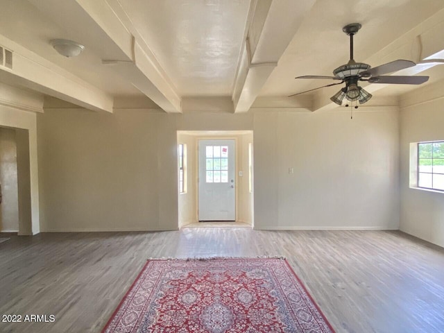 entryway with baseboards, beamed ceiling, wood finished floors, and ceiling fan