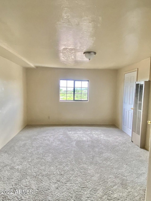 empty room featuring light carpet
