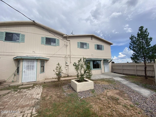 back of house with a patio and fence