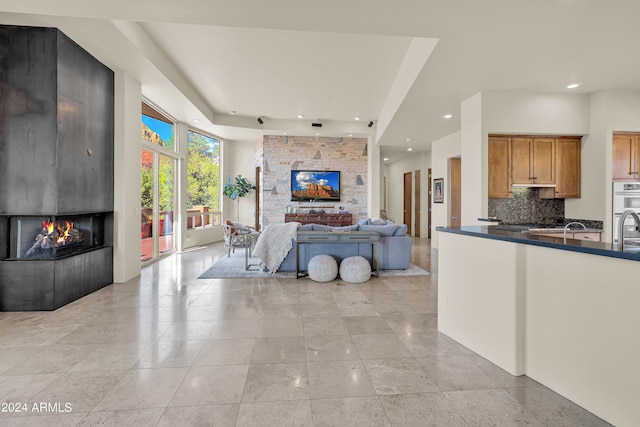 living area featuring a fireplace, light tile patterned floors, and recessed lighting