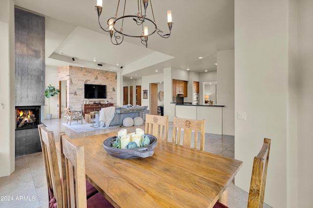 dining room featuring an inviting chandelier, recessed lighting, and a multi sided fireplace